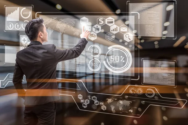 İş adamının soyut görüntüsü holograma ve bulanık şehir manzarasına işaret ediyor. İletişim ağı, siber güvenlik, internet ve gelecekteki yaşam kavramı..