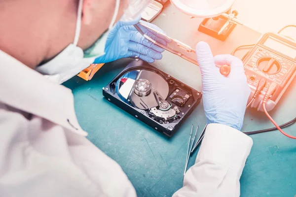 The abstract image of the technician repairing inside of hard disk drive by voltage meter. the concept of data, hardware, technician and technology.