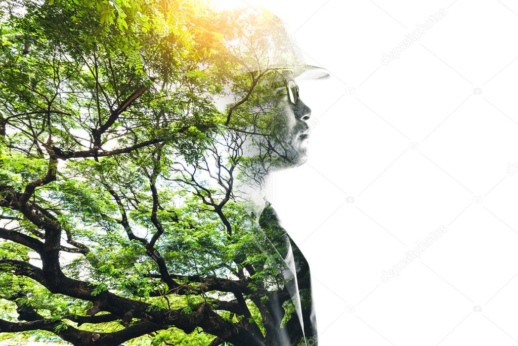 engineer thinking during sunrise overlay with forest image and white copy space. the concept of clean energy, futuristic, industrial