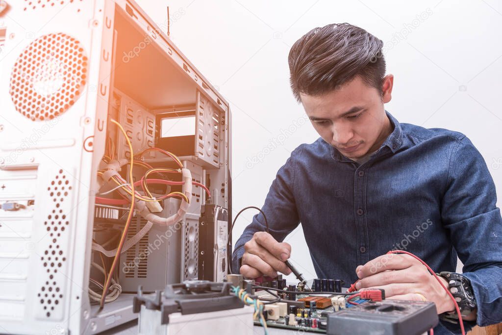 The abstract image of the technician using voltage meter for voltage measurement in computer mainboard. the concept of computer hardware, repairing, upgrade and technology.