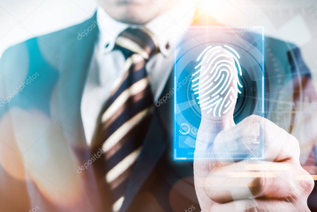 The abstract image of the businessman use a thumb scanning overlay with futuristic hologram. the concept of fingerprint, biometric, information technology and cyber security.