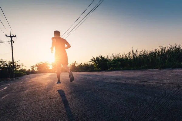 the man are running during the sunrise on the road. the concept of ennergy, activity, healthy, lifestyle and running.