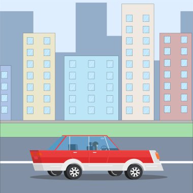 Araba şehrin ortasından geçerek gidiyor. Mavi şehir ve bulutlu güneşli bir gün. Kırmızı araba..