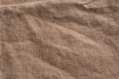 Çuval bezinden örülmüş kumaş dokusu. Bej sepia kahverengi renkli organik keten kumaş. Materyali kapat.