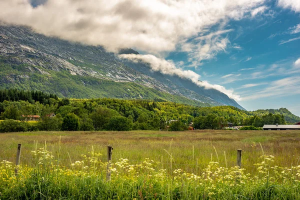 Inspirational rural countryside farmland landscape with lush green fields and mountains