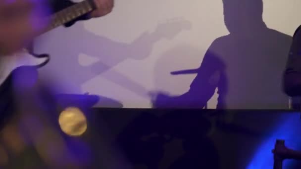 Anzeige des Gitarristen an der weißen Wand. — Stockvideo