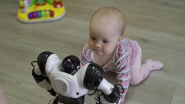 A menina olha cuidadosamente para o robô de brinquedo e dança com ele. Tecnologias robóticas modernas — Vídeo de Stock