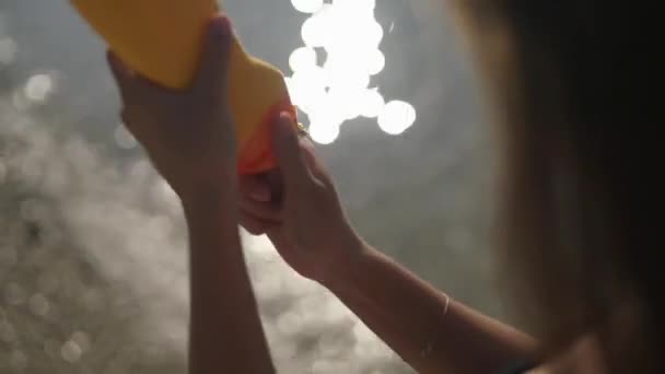 Woman squeezes sunscreen from a tube on her hand. — Stock Video