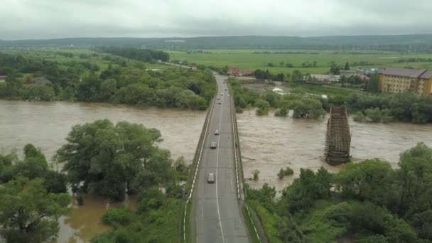 Aerial view of the bridge during floods. Extremely high water level in the river. — Stock Video