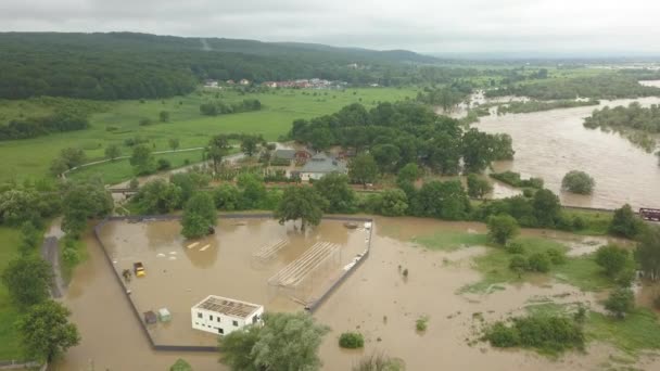 Aerial view of the overflowing river. Flooded buildings and roads. Extremely high water level in the river. Natural disaster in western Ukraine. — Stock Video