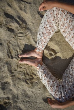 Bacak pozisyonu, ayaklar kumda meditasyon, kadın yoga yapıyor.