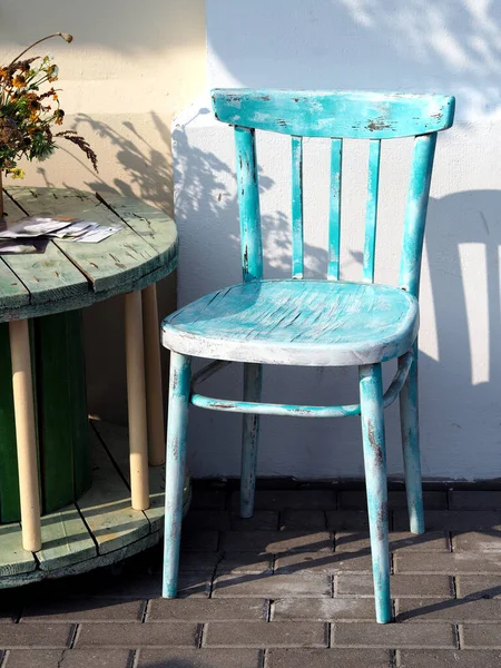 Vintage blue chair and table in outdoor cafe