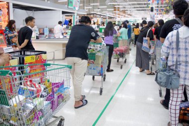 Birçok insan mal, yiyecek ve mutfak malzemesi almak için kuyrukta bekliyor. 19 virüs krizi için Lotus Alışveriş Merkezi, Bangkok, Tayland, 16 / 03 / 2020.