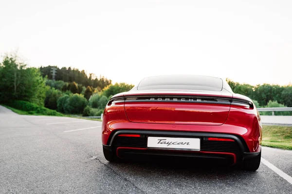 Alesund / Norveç - 31 Mayıs 2020: Tanıtım amaçlı park edilmiş kırmızı lüks Porsche Taycan sedan. Arkadan vurulmuş..