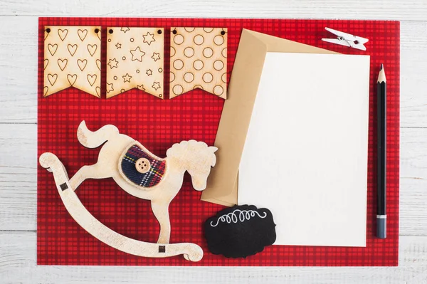 Blank paper note, craft envelope on red checkered background