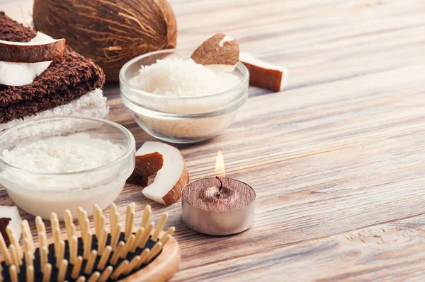 Natural hair treatment with coconut oil. Spa set with wooden hairbrush