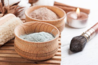 Kırmızı ve mavi kozmetik Fas kil tozu, beyaz arka plan üzerinde yanan mum ile spa kompozisyon