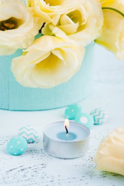 Sarı eustoma çiçekler, mavi masada yanan mum. Doğum günü, kadın ya da anneler günü için tebrik kartı