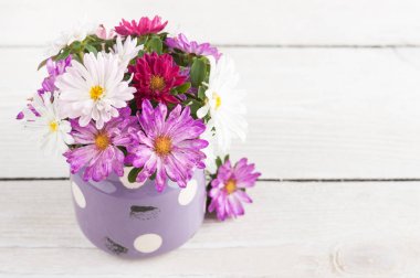 Ahşap arka plan üzerinde eski tencerede pembe mor Bahçe çiçek