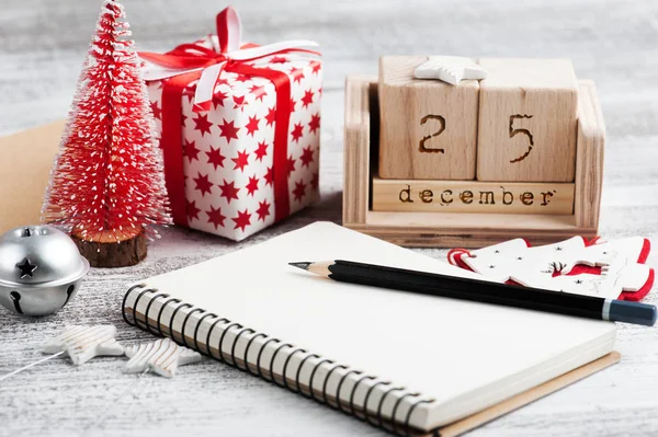 Empty note book for new year resolutions and red christmas decorations