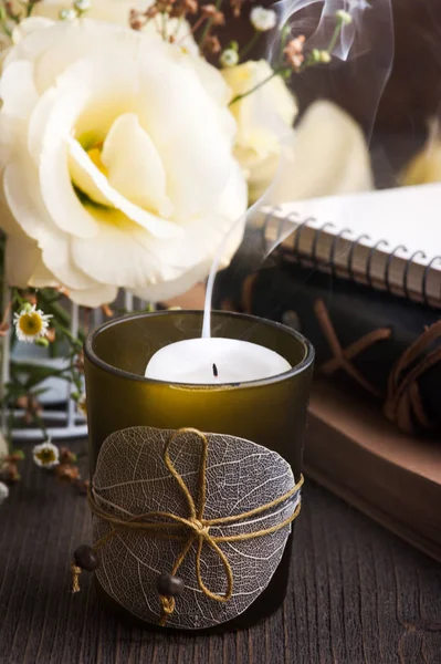 Yellow lisianthus flowers and candle — Stock Photo, Image