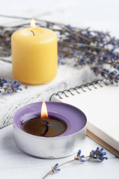 Empty open notebook with dry lavender flowers. Aromatherapy arrangement, zen still life with lit candles
