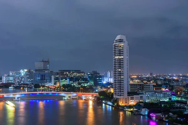 high building at the river in night time