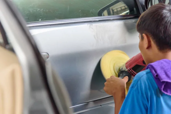 Worker polish the car by Car polishing machine