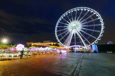 Gece karnaval parkında aydınlatma ile dönme dolap hareketli bulanıklık döndürmek  