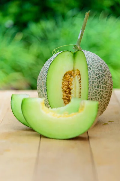 Fresh Green melon on wood plate