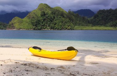 Sarı kano kumsalda, egzotik tropikal seyahat noktalarının sahillerinde Pasumpahan Adası, Padang, Batı Sumatra, Endonezya