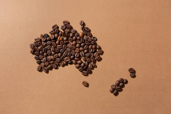Australia map made with coffee beans on brown background