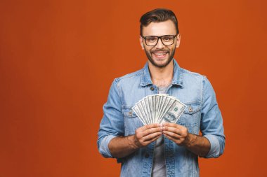 Turuncu duvar arkasında yalnız poz veren heyecanlı, genç sakallı adamın görüntüsü..