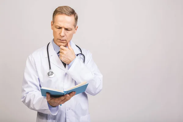 Senior doctor reading a book isolated over grey background.