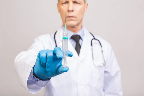 Starszy Lekarz Niebieskich Rękawiczkach Trzyma Medyczną Strzykawkę Wstrzykiwań Odizolowaną Szarym — Zdjęcie stockowe