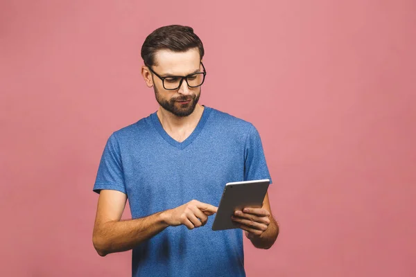 Šťastný Mladý Muž Ležérní Stojící Pomocí Tablet Přes Růžové Pozadí — Stock fotografie