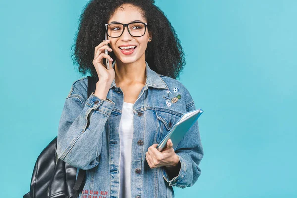 African american black student woman using smartphone standing over isolated over blue background.