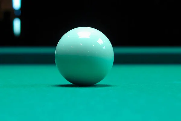 white billiard ball without a number on a pool table