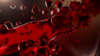 Wine is pouring in slow motion. Splash of alcohol, red wine. 