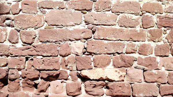 wall of large red stones