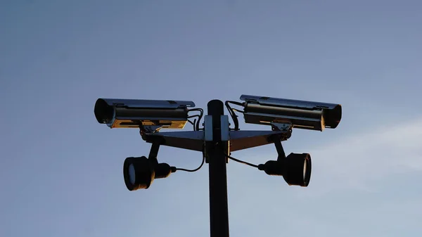 surveillance cameras against sky background