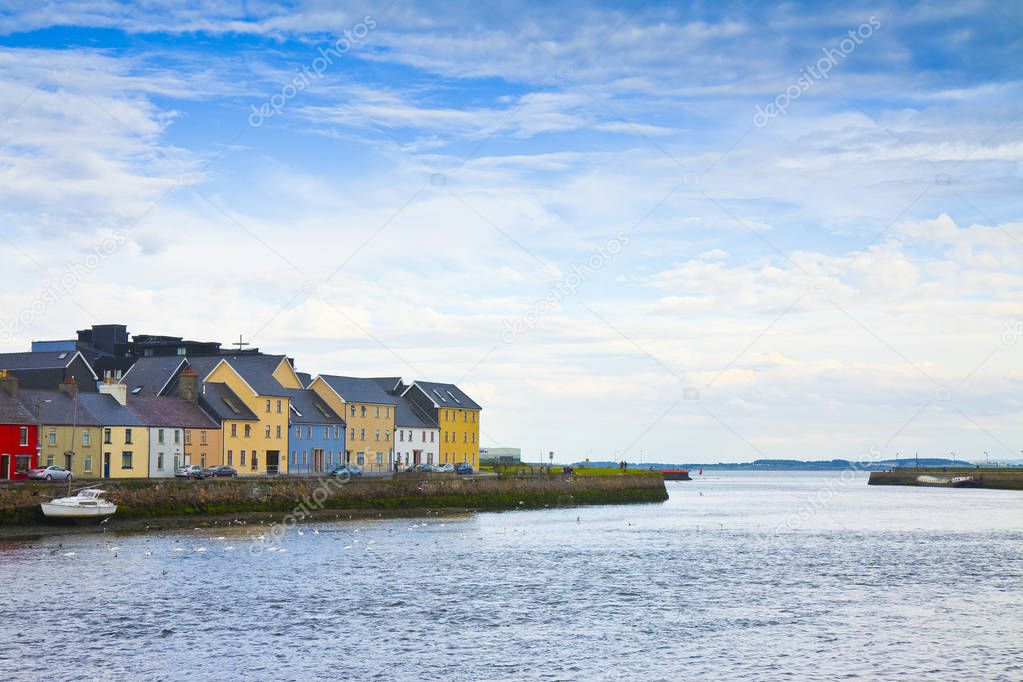 Irish coastal landscape with the typical colored fishermen's houses with sloping roofs (Galway - Ireland)