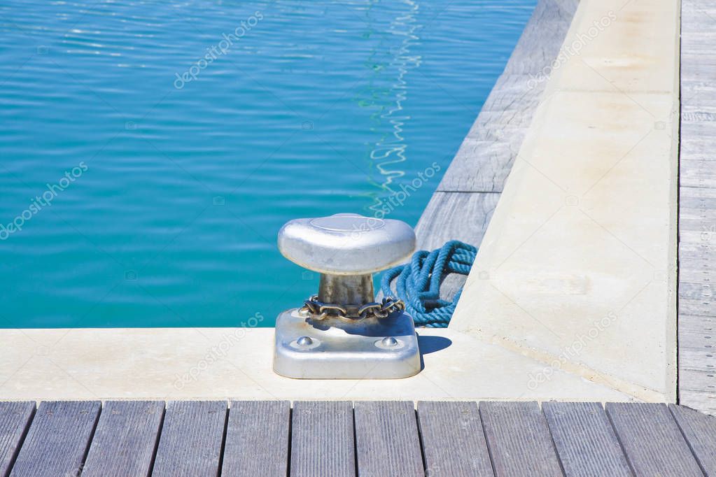 Cleat for mooring boats on wooden platform - image with copy spa
