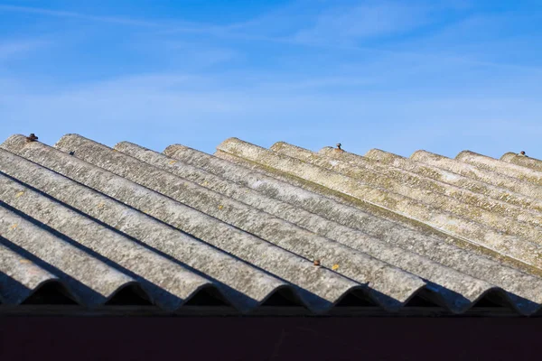 Old aged dangerous asbestos roof made of concrete panels