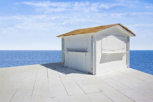 Pequena casa de campo de madeira branca com telhado de palha pelo mar - imagem — Fotografia de Stock