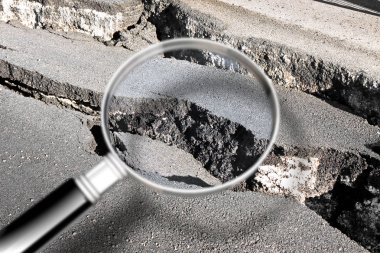 Cracked asphalt road damaged after a structural failure - Concep clipart