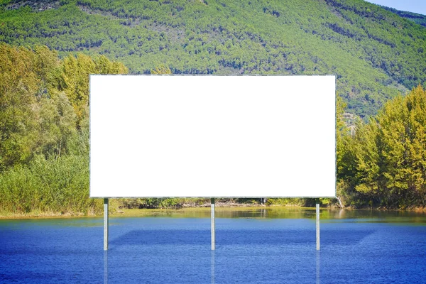 Blank advertising billboard against a calm lake - concept image