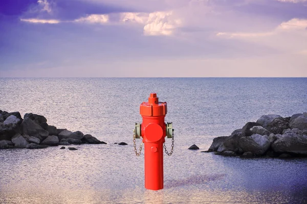 Un hidrante improbable en la orilla del mar. Un montón de concepto de agua im —  Fotos de Stock