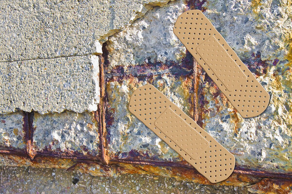 Reinforced concrete with damaged and rusty metallic reinforcemen