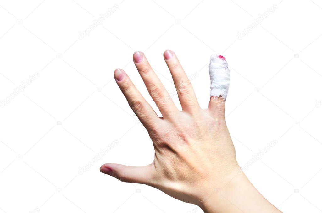 Close-up of a female hand with injured bleeding finger with bloody gauze on it.